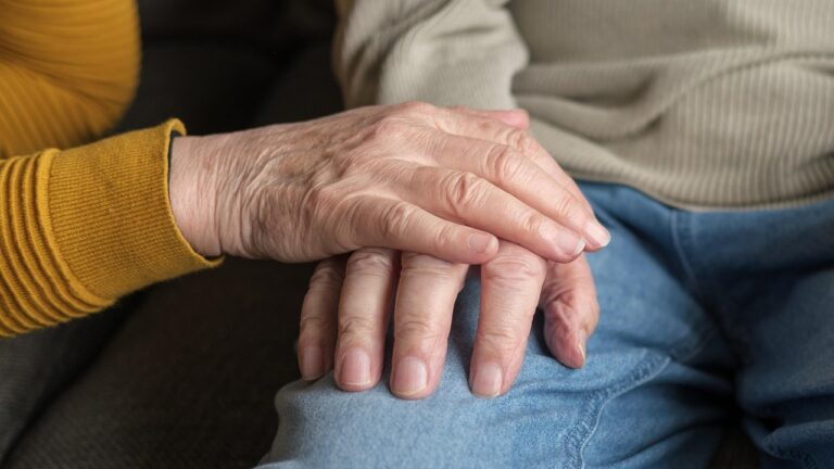 Trzymające się dłonie seniorów